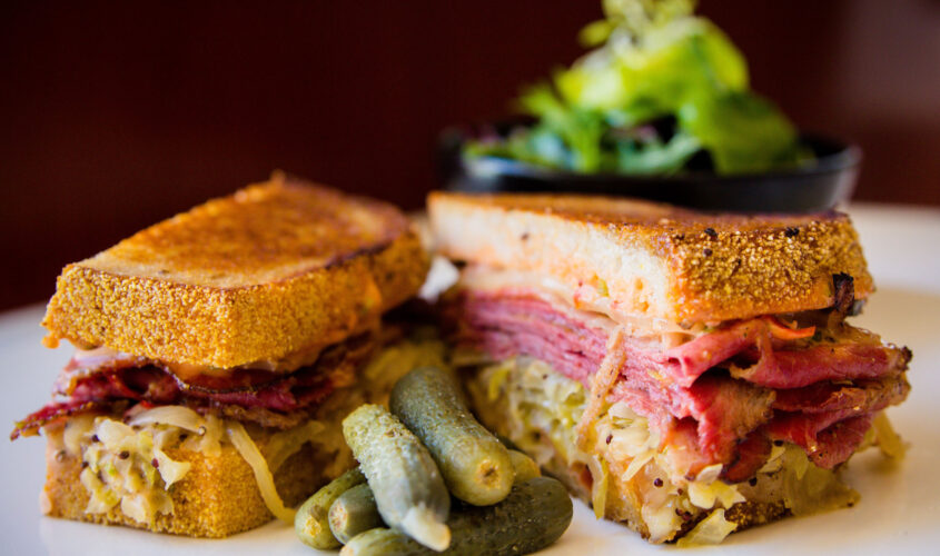 NINE-TEN Reuben Sandwich with House-made Pastrami, Swiss Cheese, Sauerkraut, 910 Russian Dressing, New York Corn Rye Bread