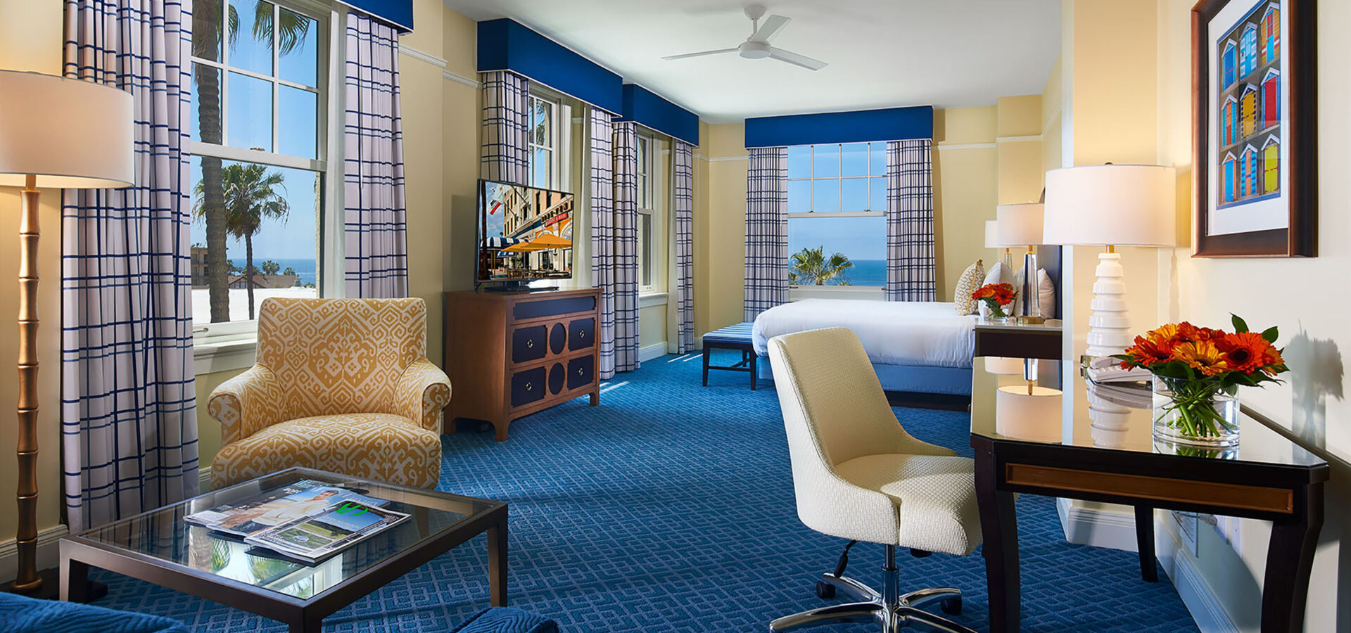 ocean-view-king-junior-suite - Living room with chairs and tables with windows showing an ocean view