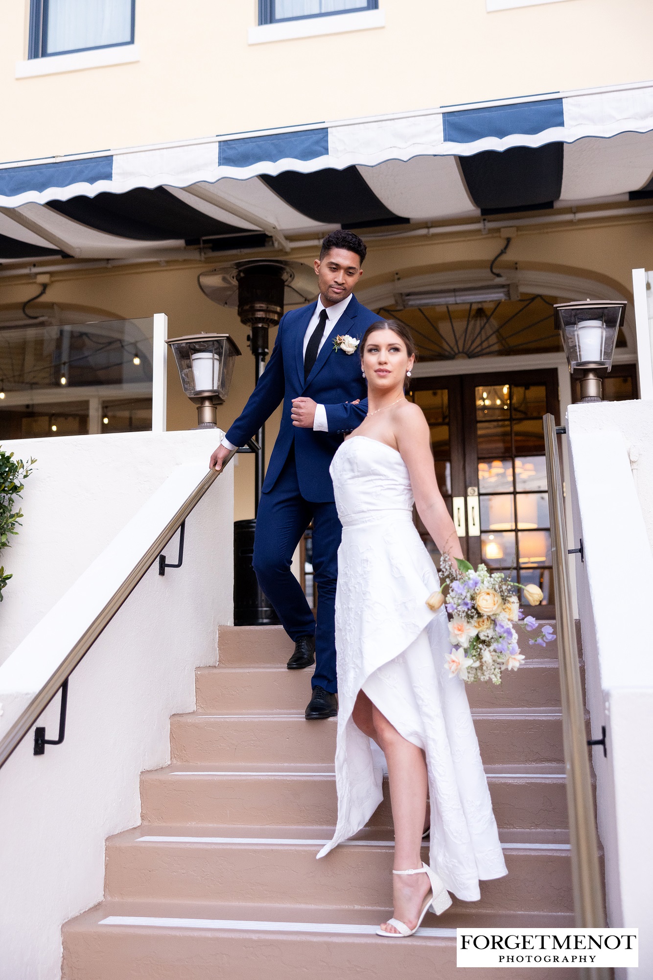 Bride and groom standing on stairs