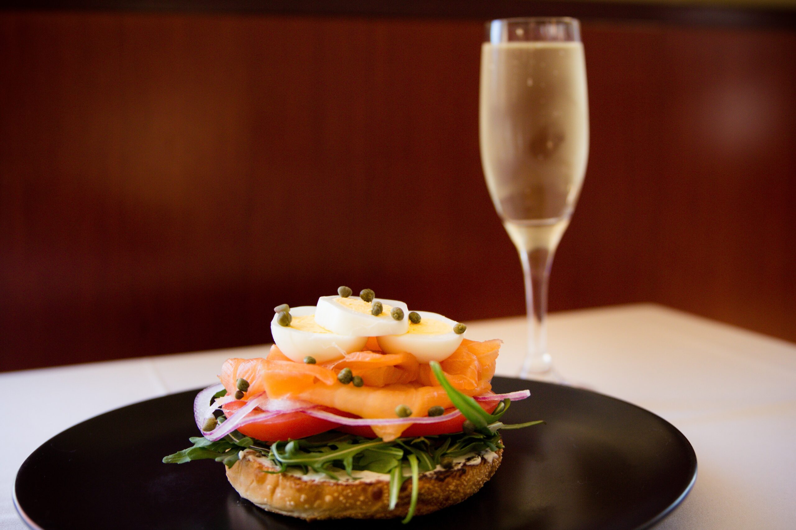 Photo of Smoked Salmon Bagel with Glass of Champagne