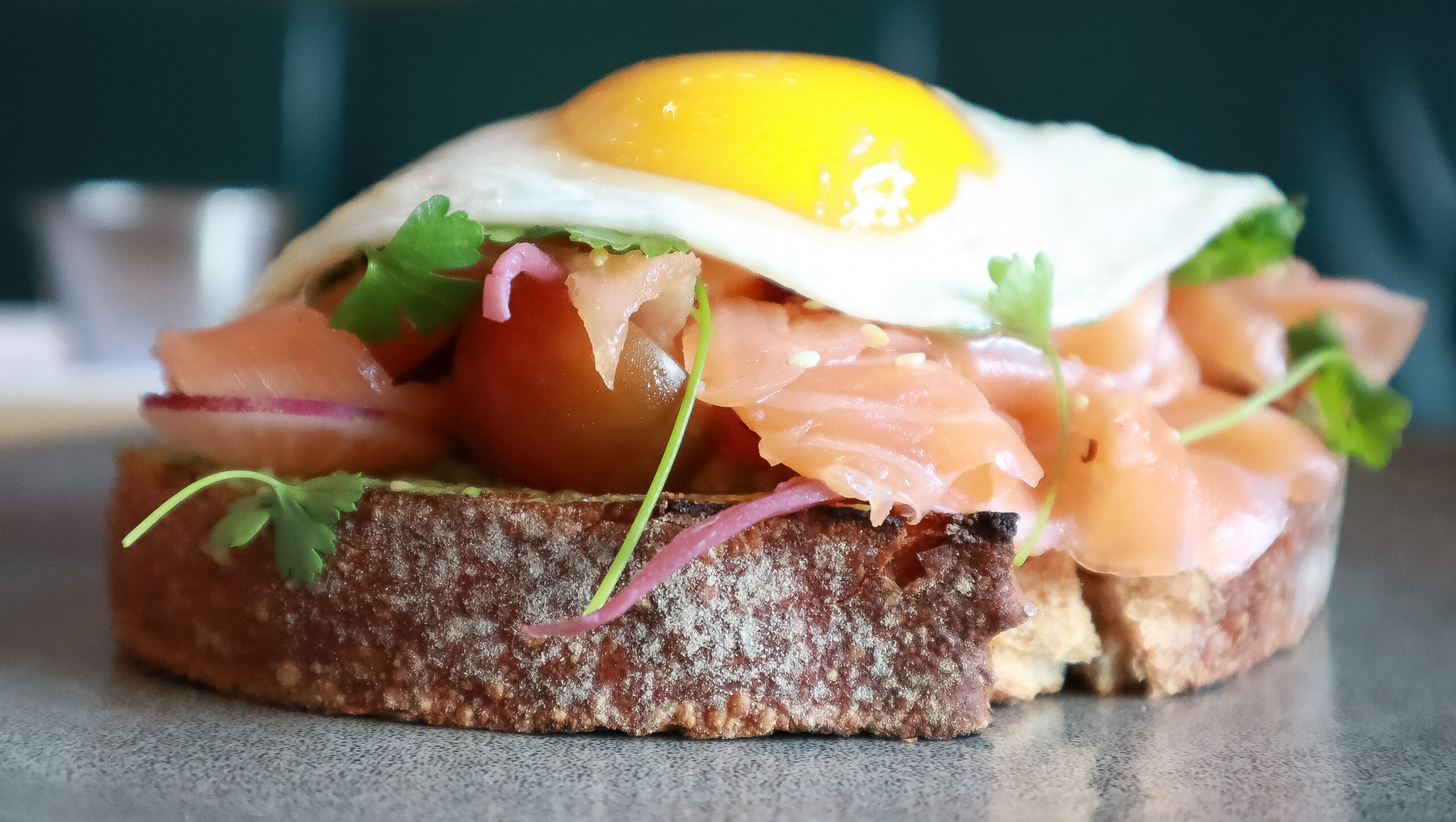 close up of salmon and avocado toast with an egg