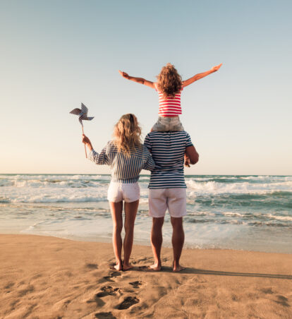 photo of a family standing on beach