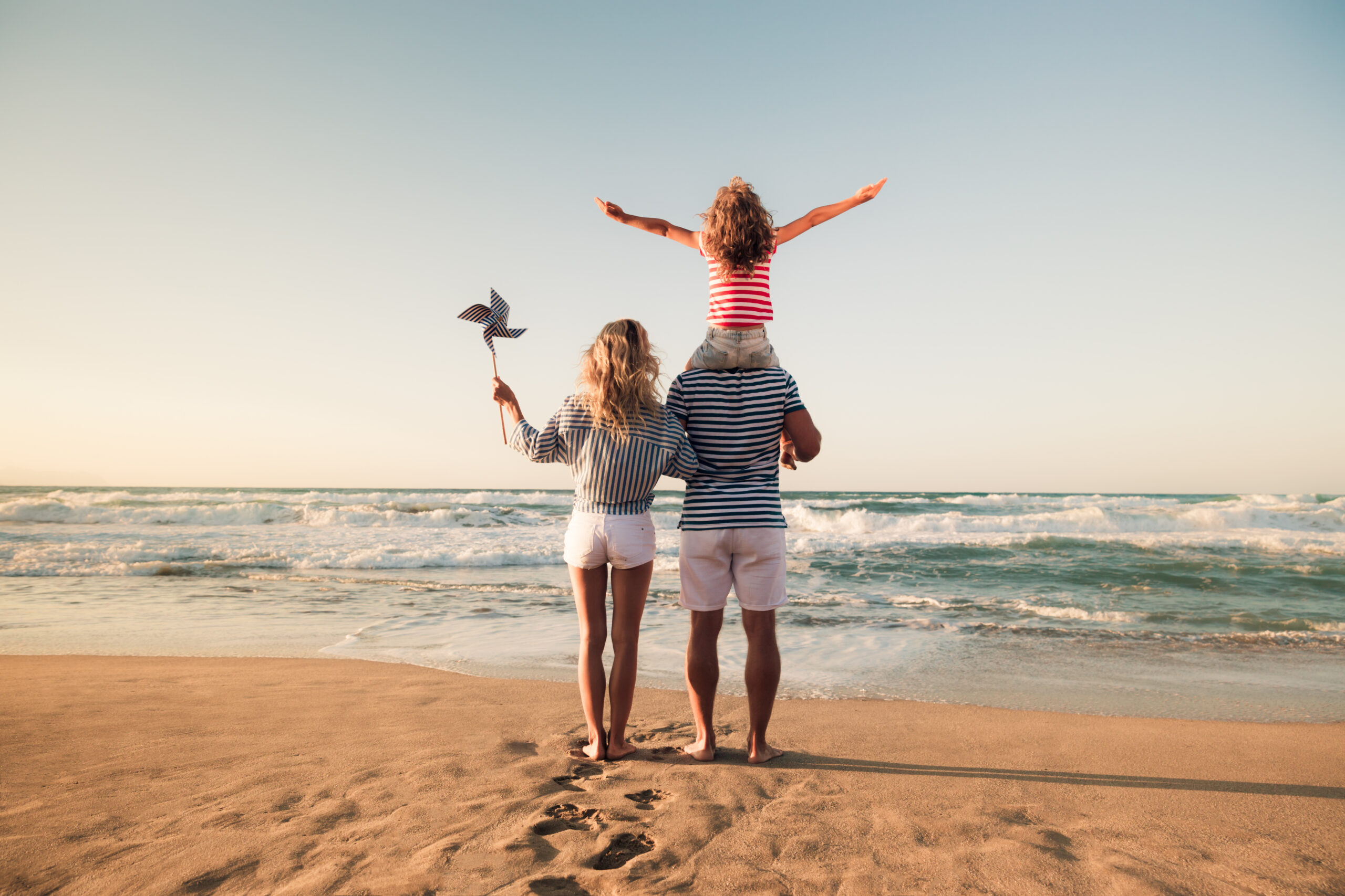 photo of a family standing on beach